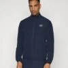 EA7 Emporio Armani GOLF PRO TECH - Training Jacket - Blue -Total Wear Store d1ebdcac6d97435398885a2fea8ef460