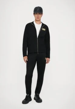 EA7 Emporio Armani TRAIN LABEL ALCANTARA - Tracksuit Bottoms - Black -Total Wear Store f0b537cde73c4251ad6db02e3cd09b7c